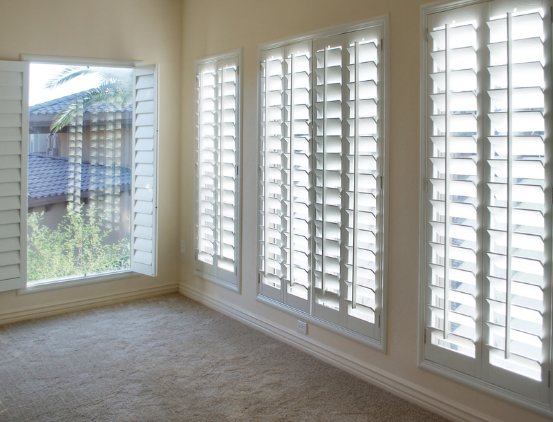 White plantation style wood Shutters for luxury Interior Design in condo.